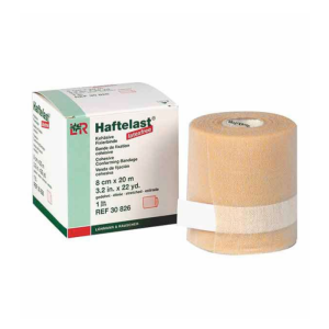 Een rolletje haftelast naast het doosje ervan.